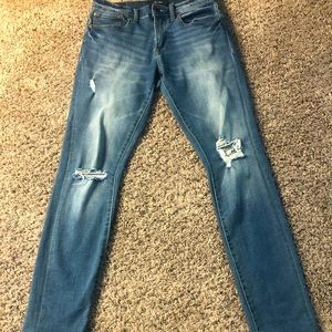 Size 29/32 skinny jeans with factory made rips